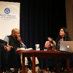 DJ Spooky aka Paul D. Miller looking at Nayda Collazo-Llorens with his hand on his chin